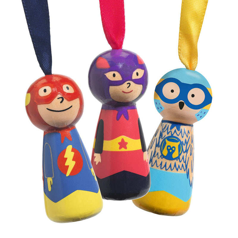 Three colorful superhero figurines with ribbons on a white background