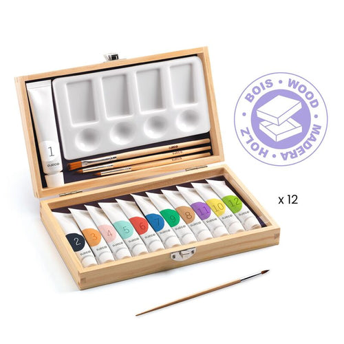Wooden art set with paint tubes, brushes, and a palette on a white background.