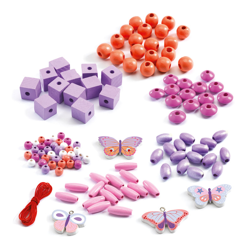 Assorted colorful beads and butterfly charms on a white background