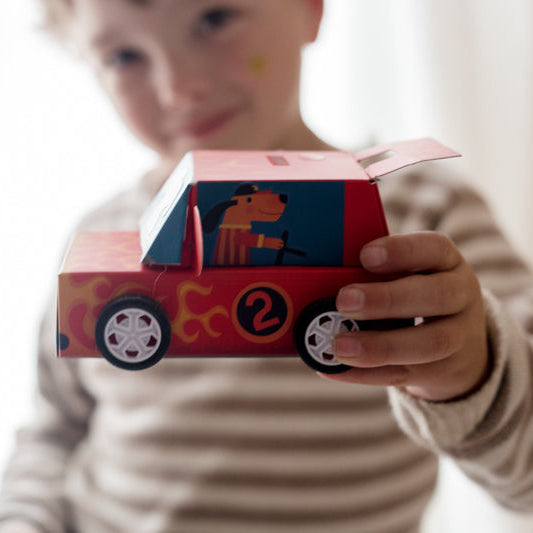 Child holding a colorful toy car with cartoon characters