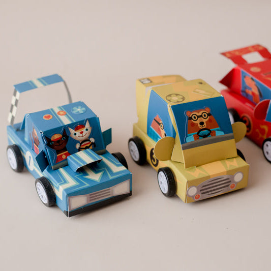 Three colorful toy cars with cartoon characters on a light gray background