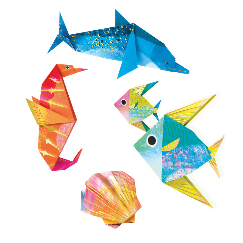 Colorful paper fish, seahorse, and shell on a white background