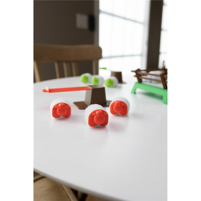 Toy sheep on a white surface with a blurred background