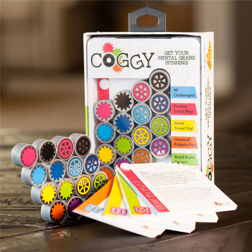 Coggy fidget toy set with packaging on a wooden surface