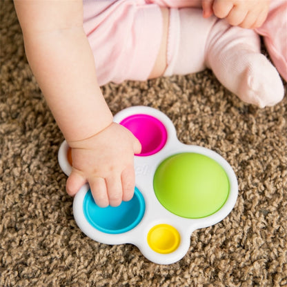 Baby playing with Fat Brain Toys - Dimpl
