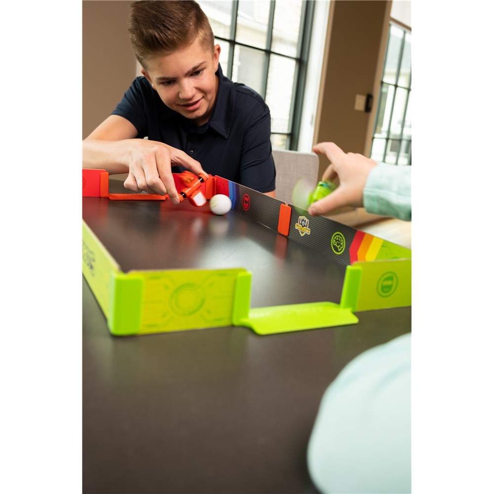 Child playing with Fat Brain Toys - Foosbots - Stadium Battle