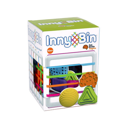A product image of Inny Bin, a shape-sorting toy with a cube and various textured geometric shapes including a triangle, sphere, and diamond, as well as the Fat Brain logo.