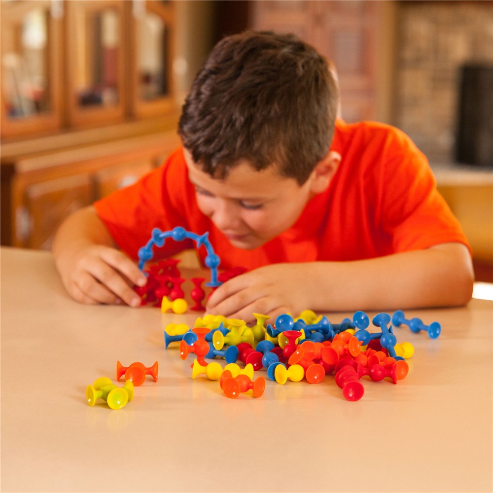 Child playing with colorful building blocks on a table