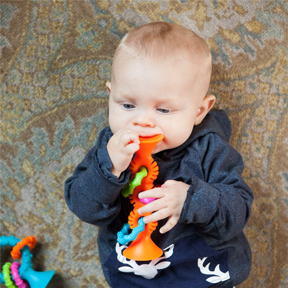 Baby playing with Fat Brain Toys - PipSquigz Loops