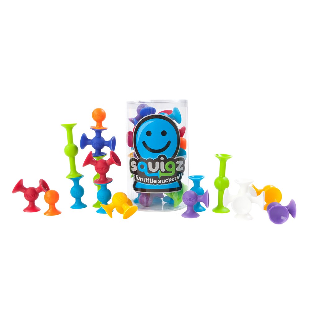 A collection of colorful Squigz suction toys displayed in various shapes and positions, with packaging visible in the background.