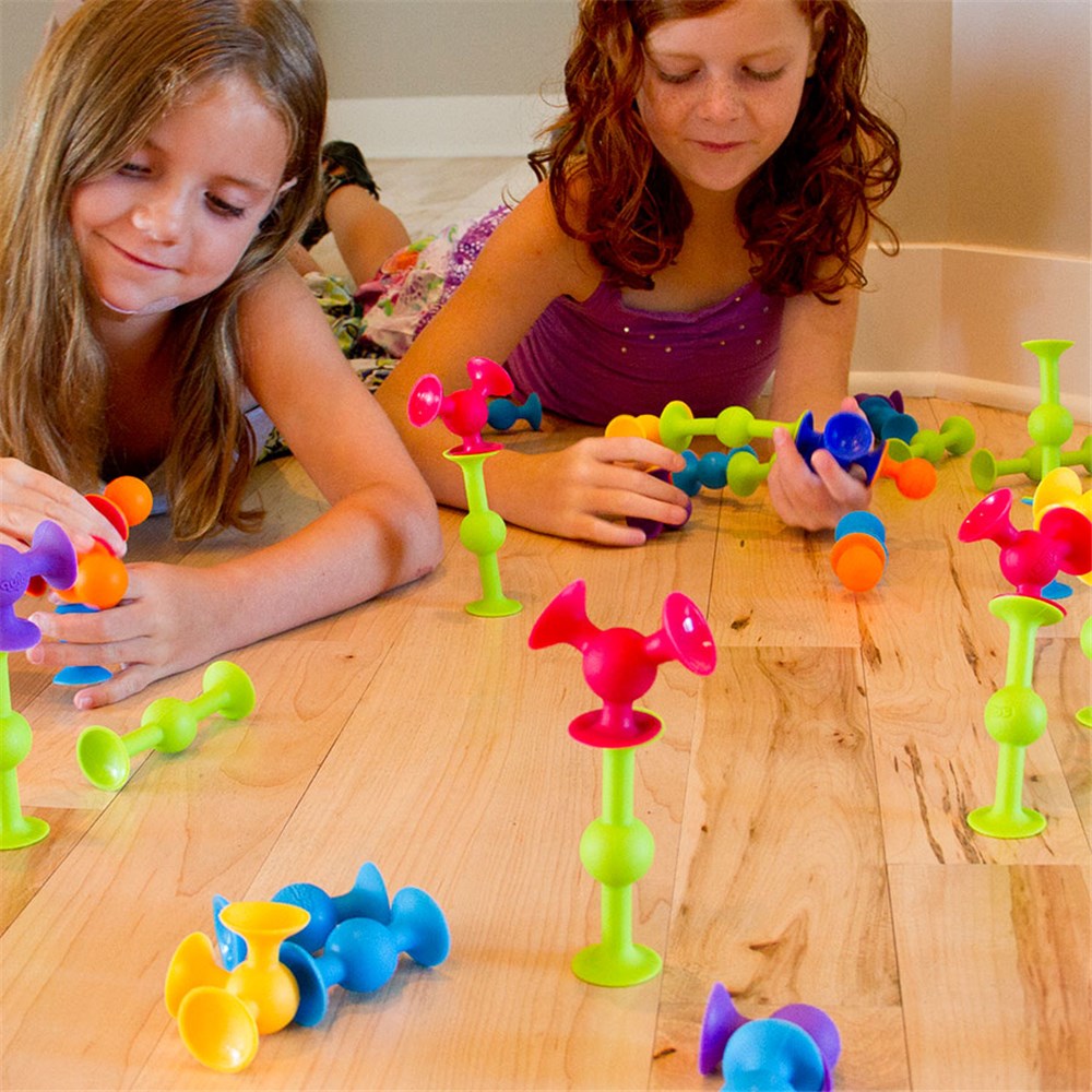 Children playing with Fat Brain Toys - Squigz 