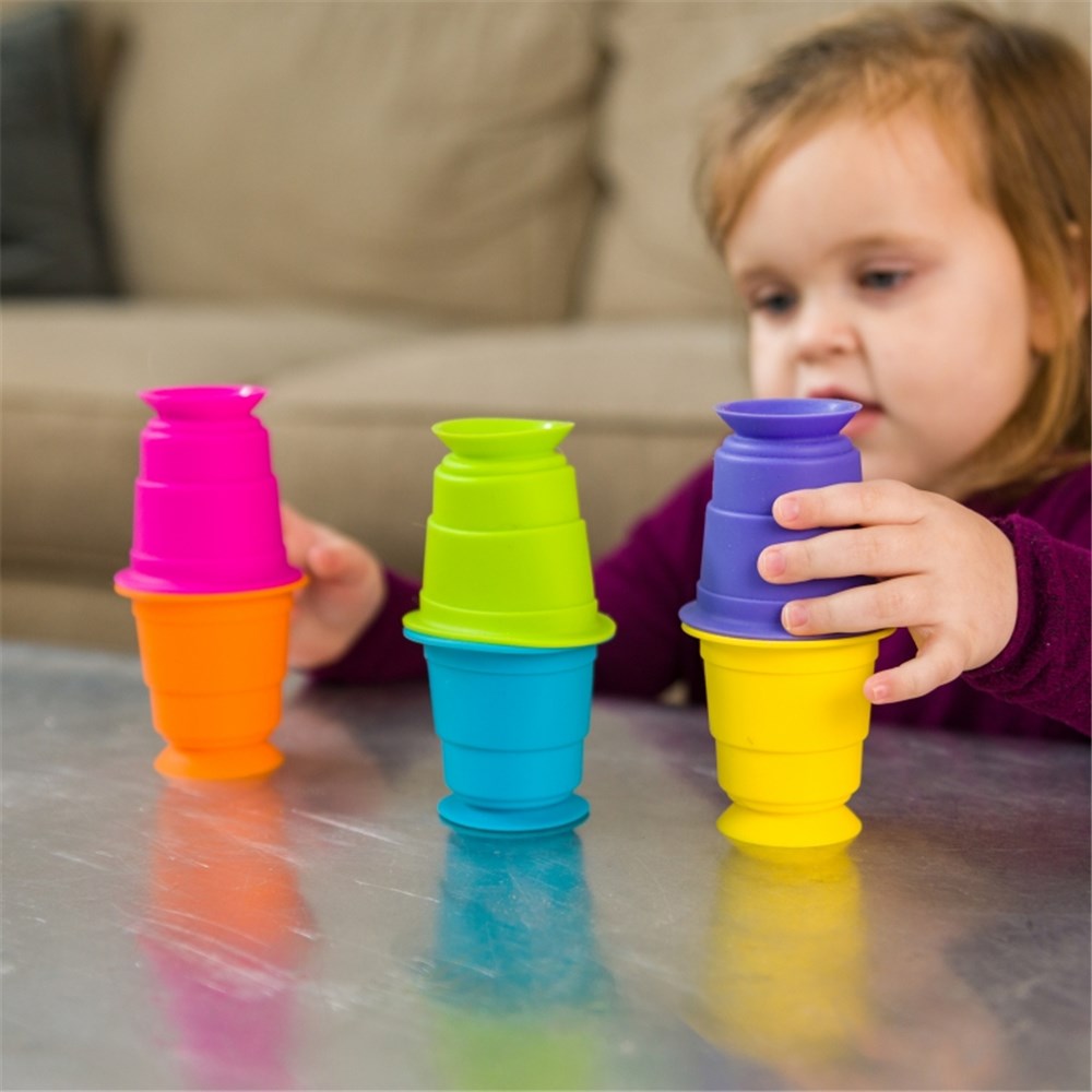 Toddler playing with Fat Brain Toys - Suction Kupz