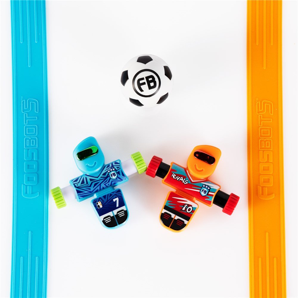 Toy robots with a soccer ball on a white background, featuring the 'FB' logo.