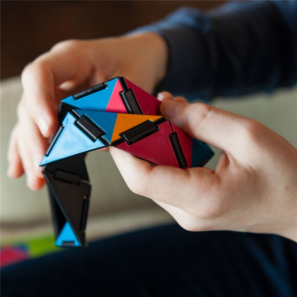 Colorful geometric puzzle being held by a person's hands