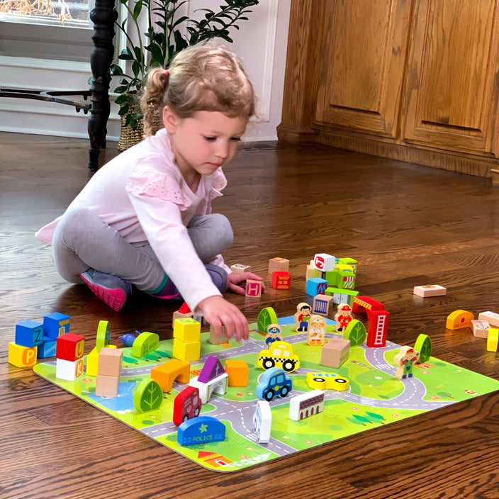 Child playing with colorful toys on a mat in a home setting