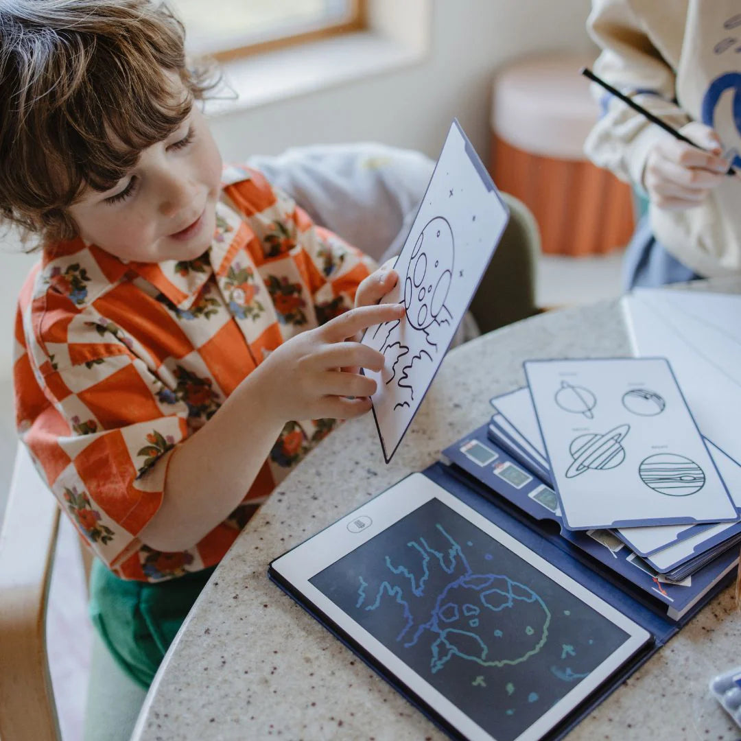 Child interacting with educational materials at a table