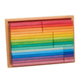 Rainbow wooden blocks arranged in a light natural wood tray on a plain white background.