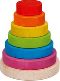 A colourful wooden stacking tower with red, orange, yellow, green, blue and purple rings on a natural wood base.