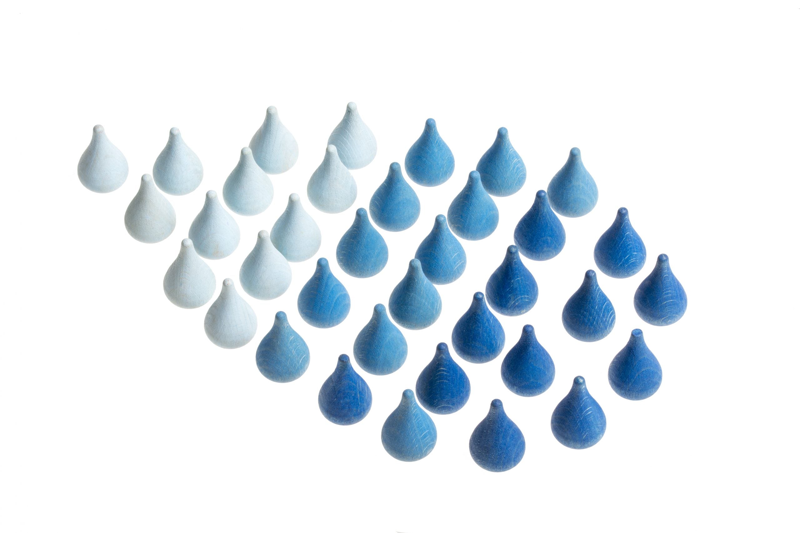 Set of blue and white wooden teardrop-shaped objects on a white background