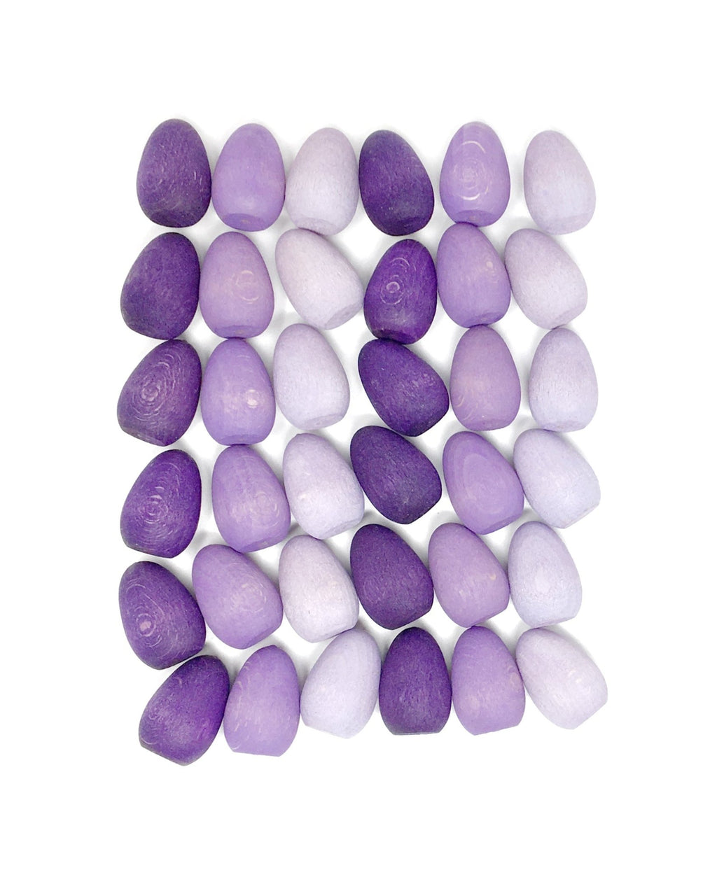 Purple and white pebbles arranged in a pattern on a white background