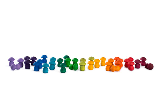 Colorful wooden pegs arranged in a line on a white background