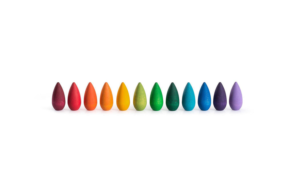 Row of colorful teardrop-shaped objects on a white background