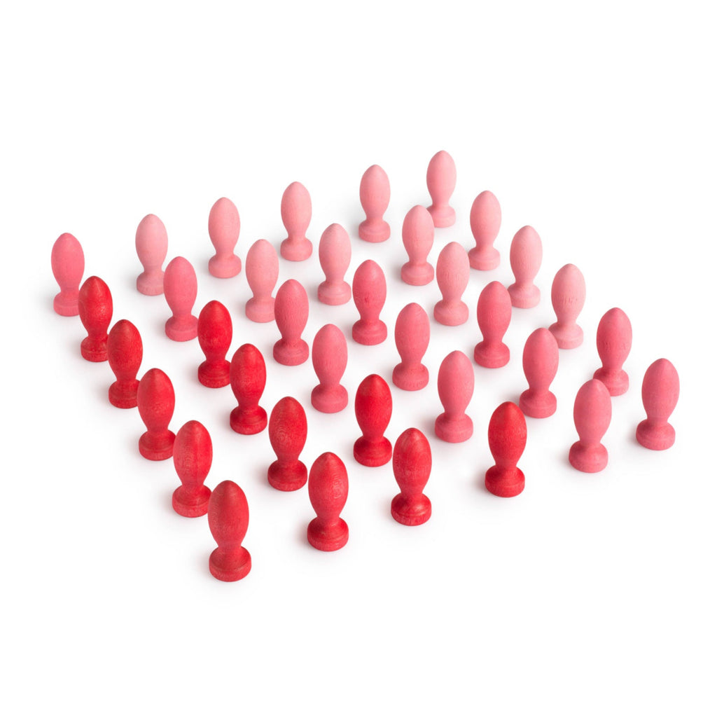 Red and pink wooden figures arranged in a pattern on a white background