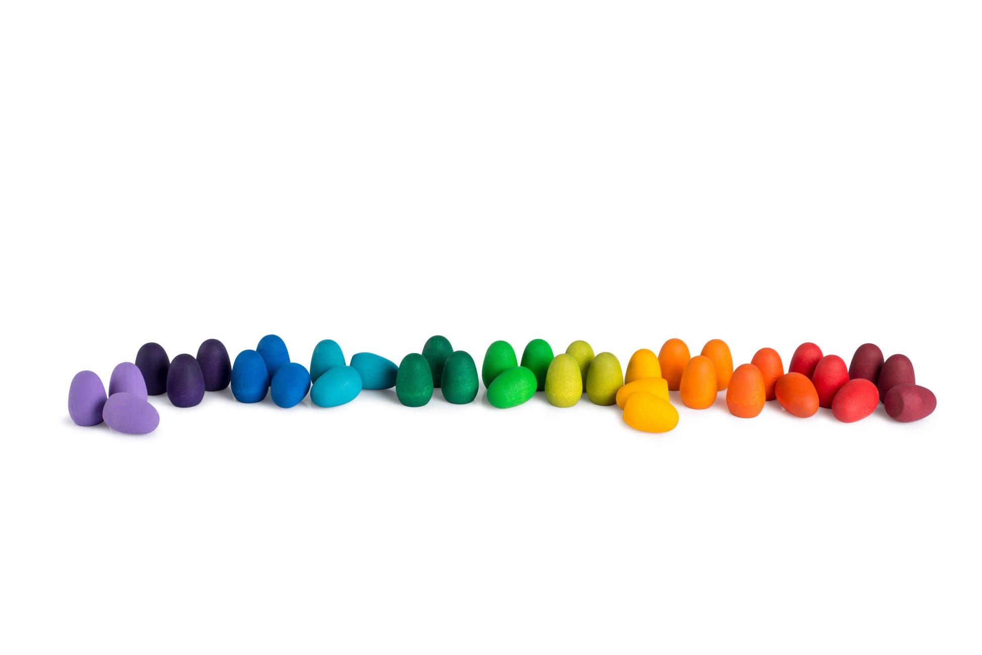 Row of colorful wooden toys on a white background