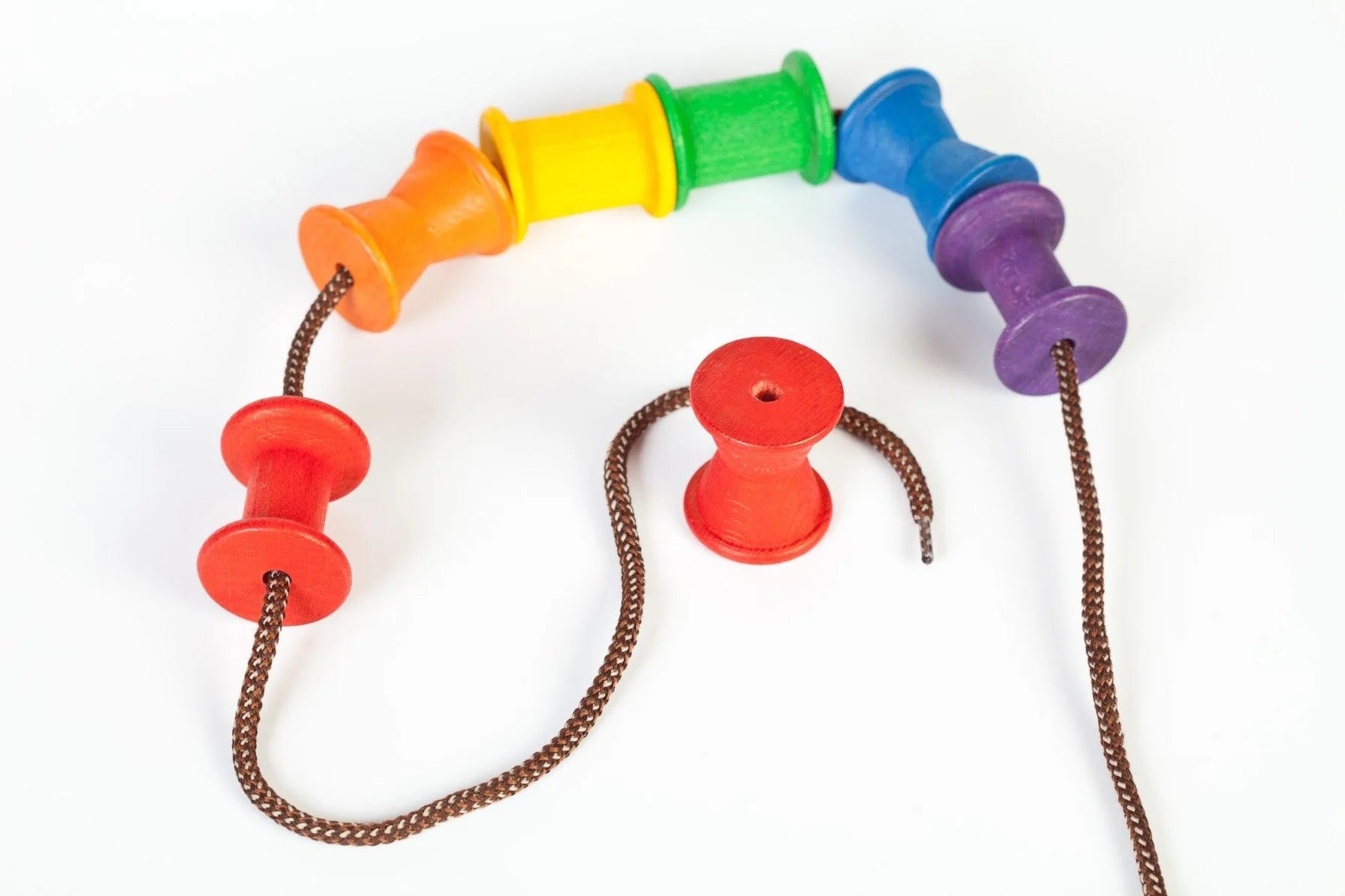 Colorful jump rope with rainbow-colored handles on a white background
