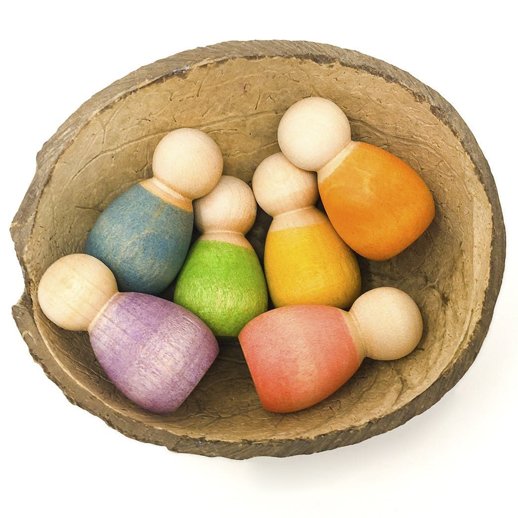 Colorful wooden pins in a rustic wooden bowl on a white background