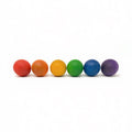 Set of six colorful wooden balls in a rainbow sequence on a white background