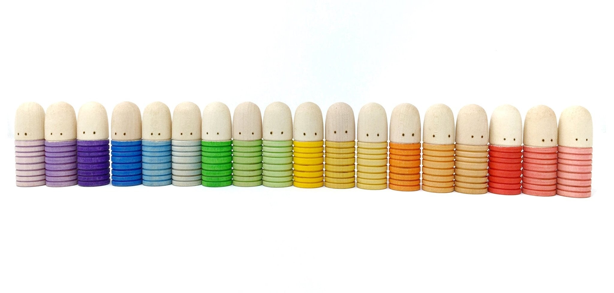 Row of small plush toys in various colors on a white background