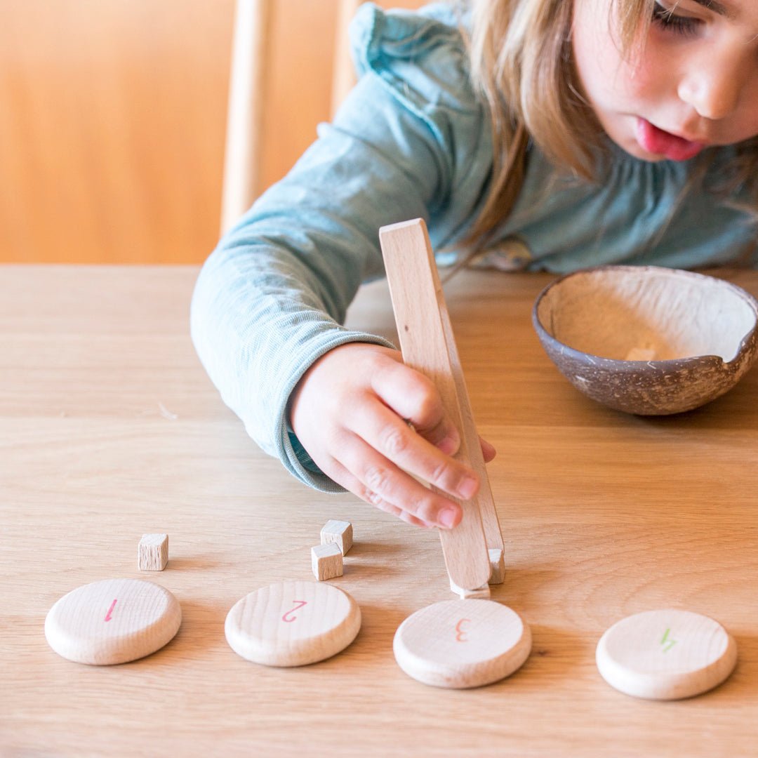Child playing with wooden toys on a table