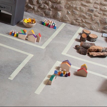 Children's toys on a concrete floor with a stone wall background