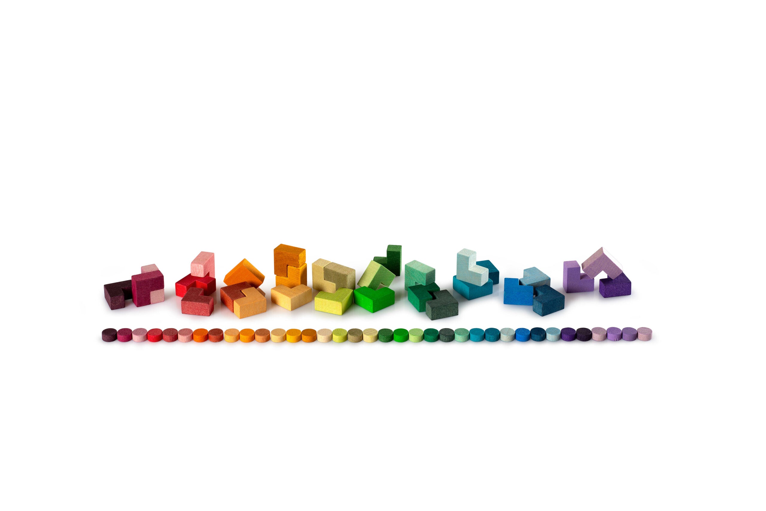 Colorful geometric building blocks arranged in a line on a white background