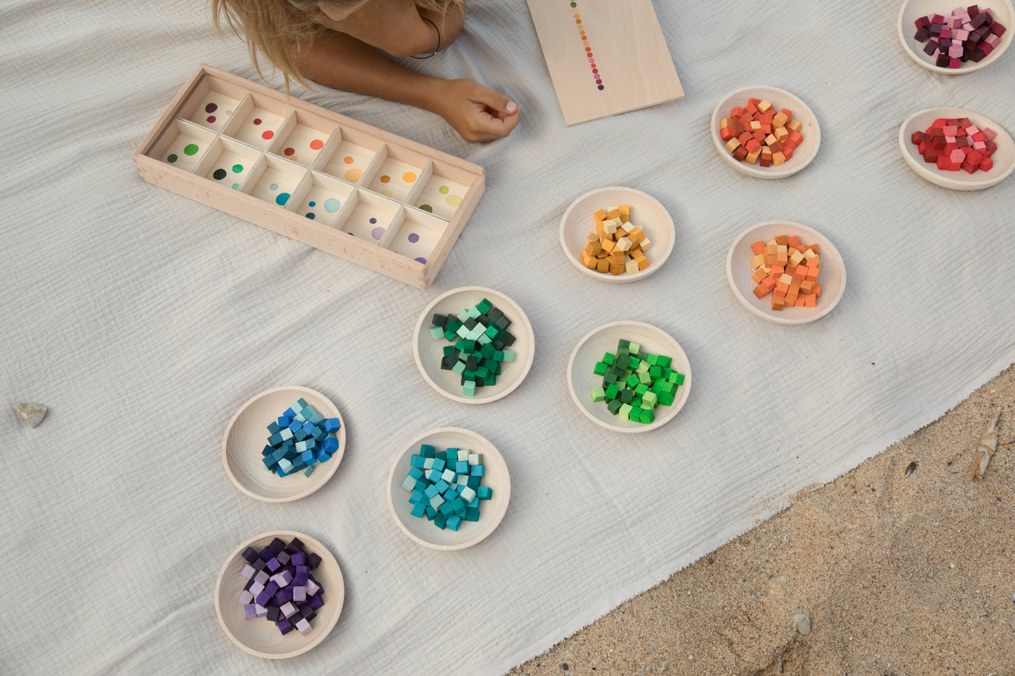 Children's educational game with colored cubes on a light surface