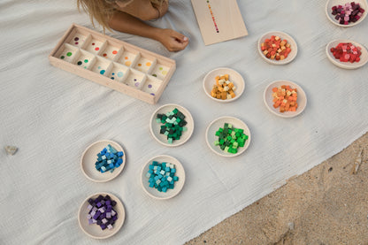 Children's educational game with colored cubes on a light surface
