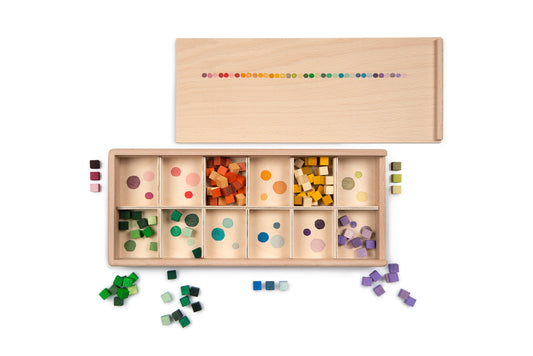 Wooden educational toy with colorful geometric shapes and a color chart on a white background