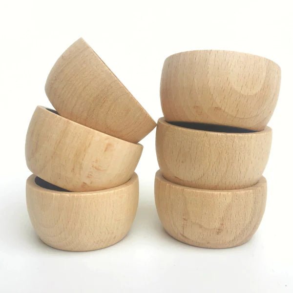 Set of wooden bowls stacked on a white background