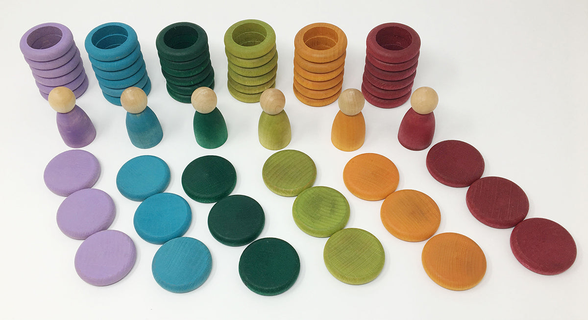 Colorful wooden pegs and discs on a white background