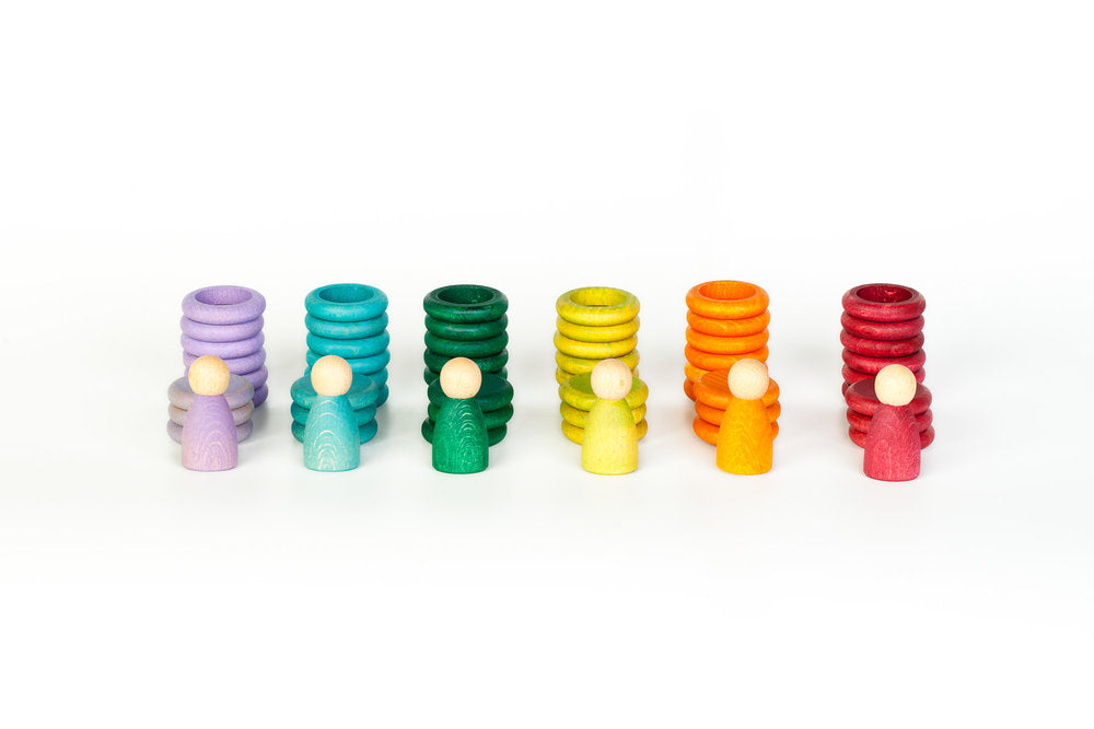 Set of colorful cylindrical containers with small round objects on a white background