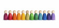 Row of colorful wooden peg dolls in a rainbow sequence on a white background