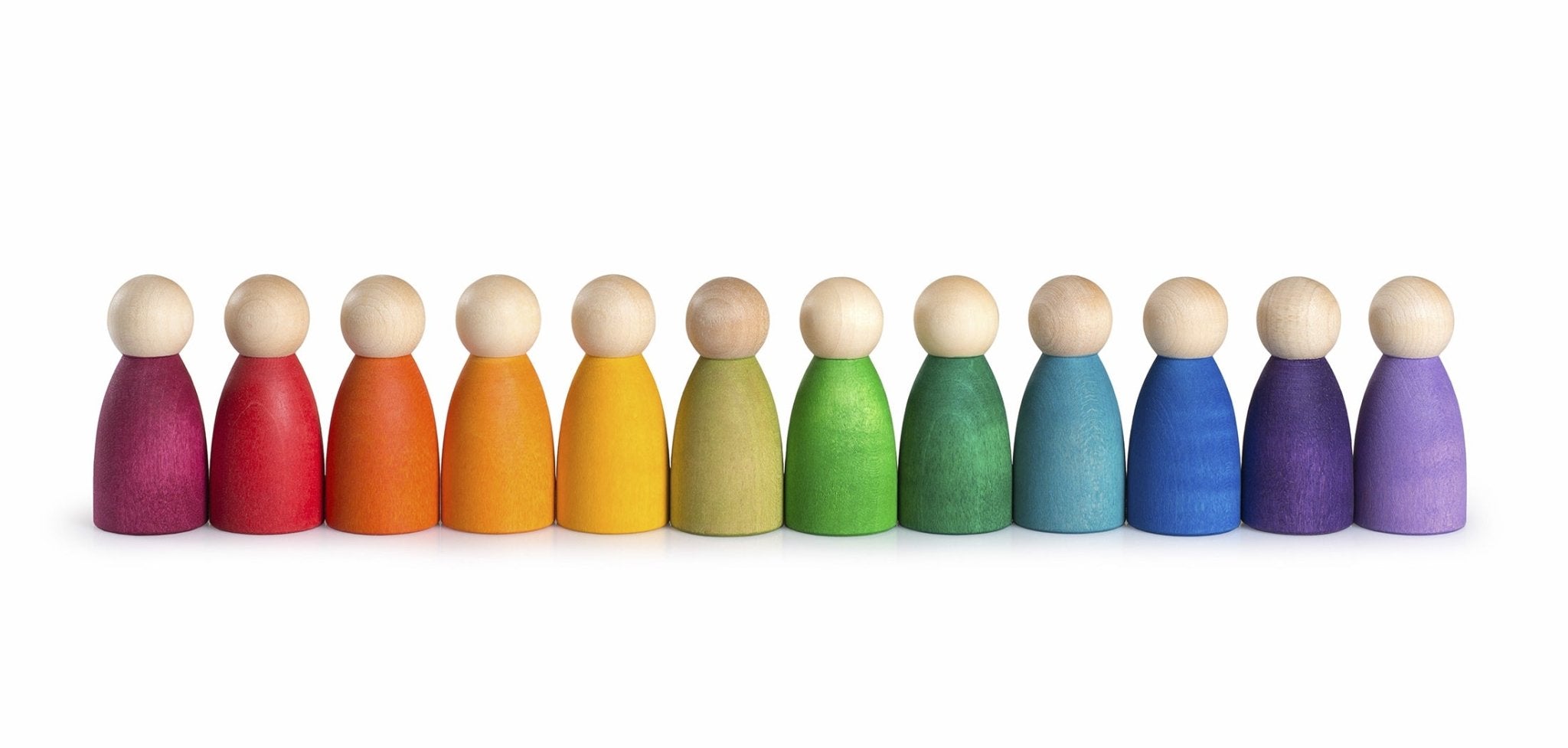 Row of colorful wooden peg dolls in a rainbow sequence on a white background