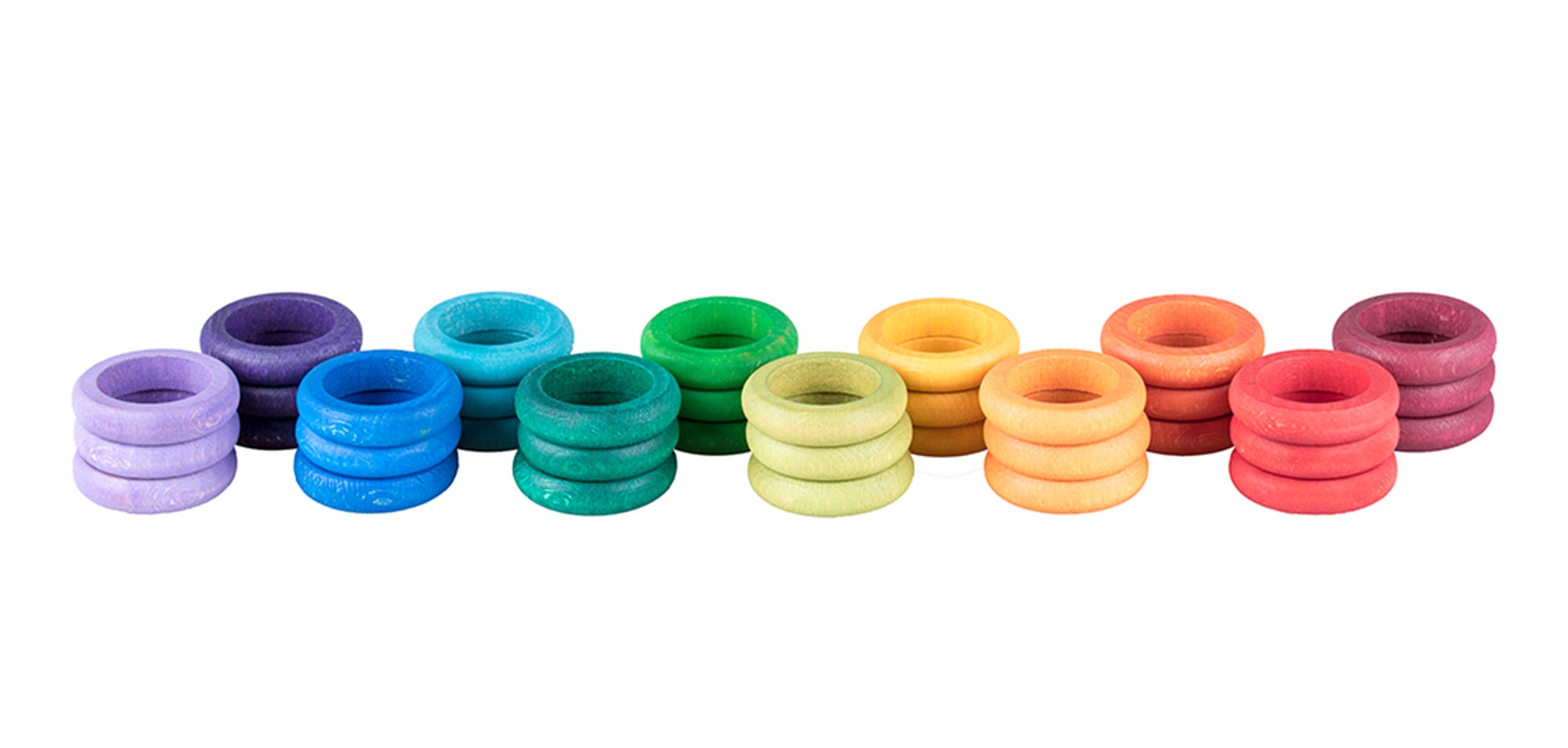 Set of colourful wooden rings in various colours on a white background