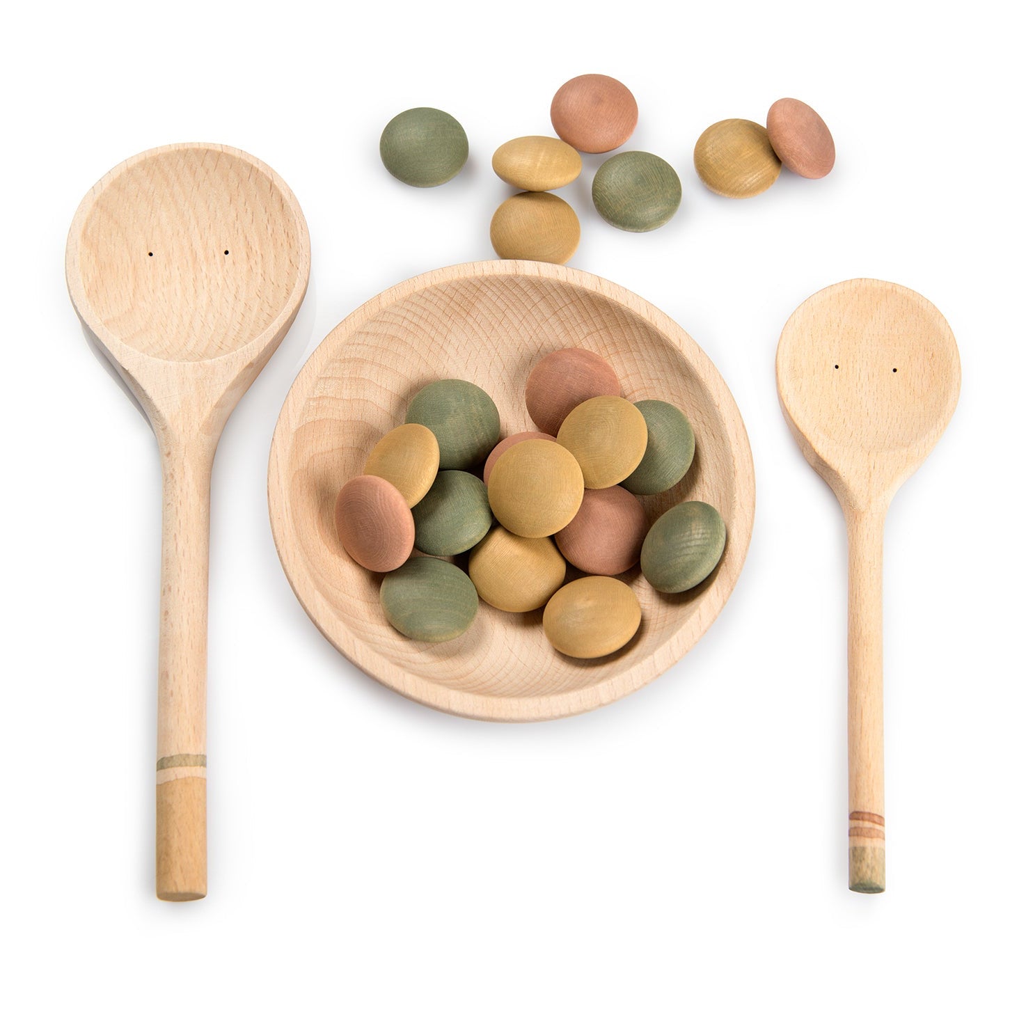 Wooden spoons and a bowl with colorful stones on a white background