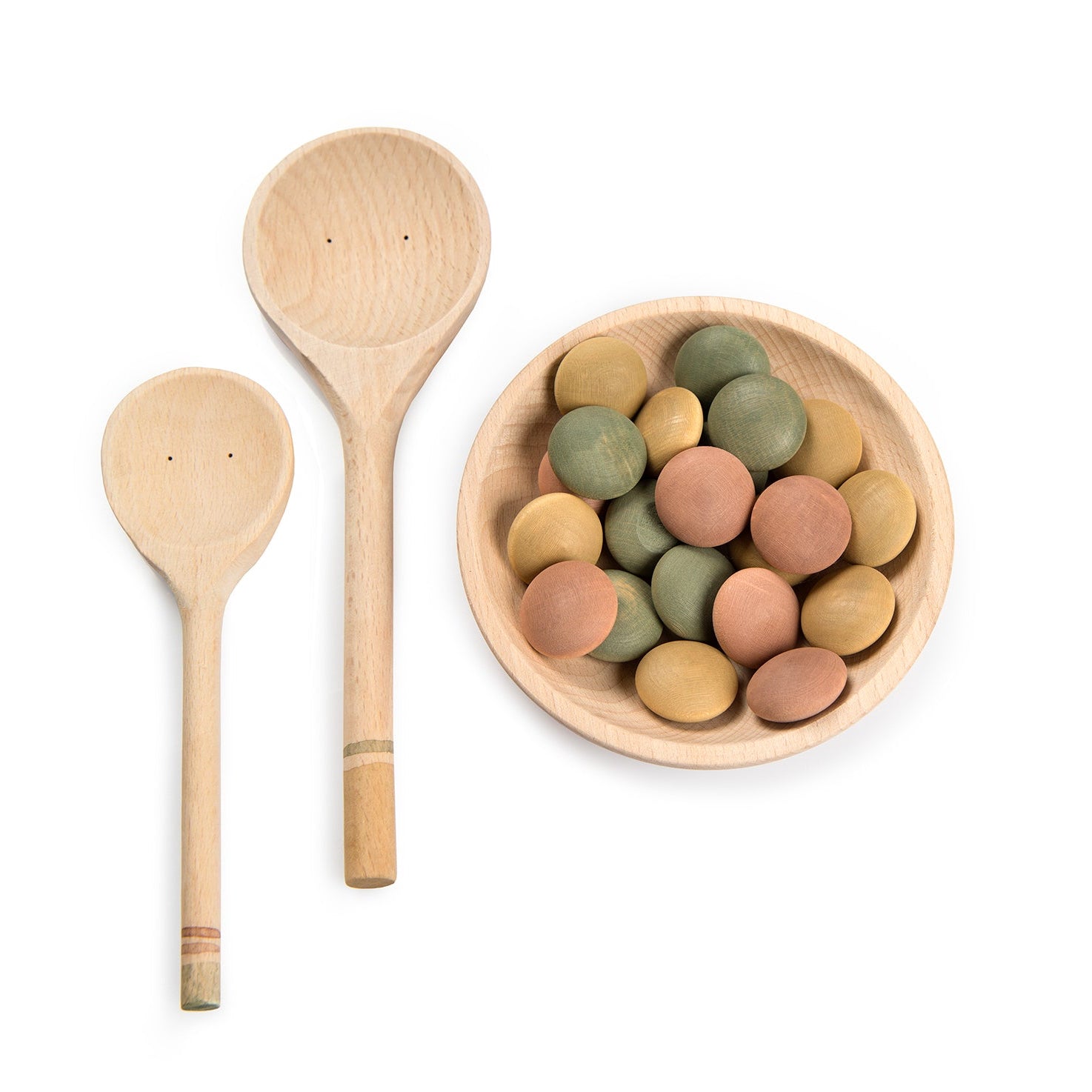 Three wooden spoons and a bowl with colorful stones on a white background