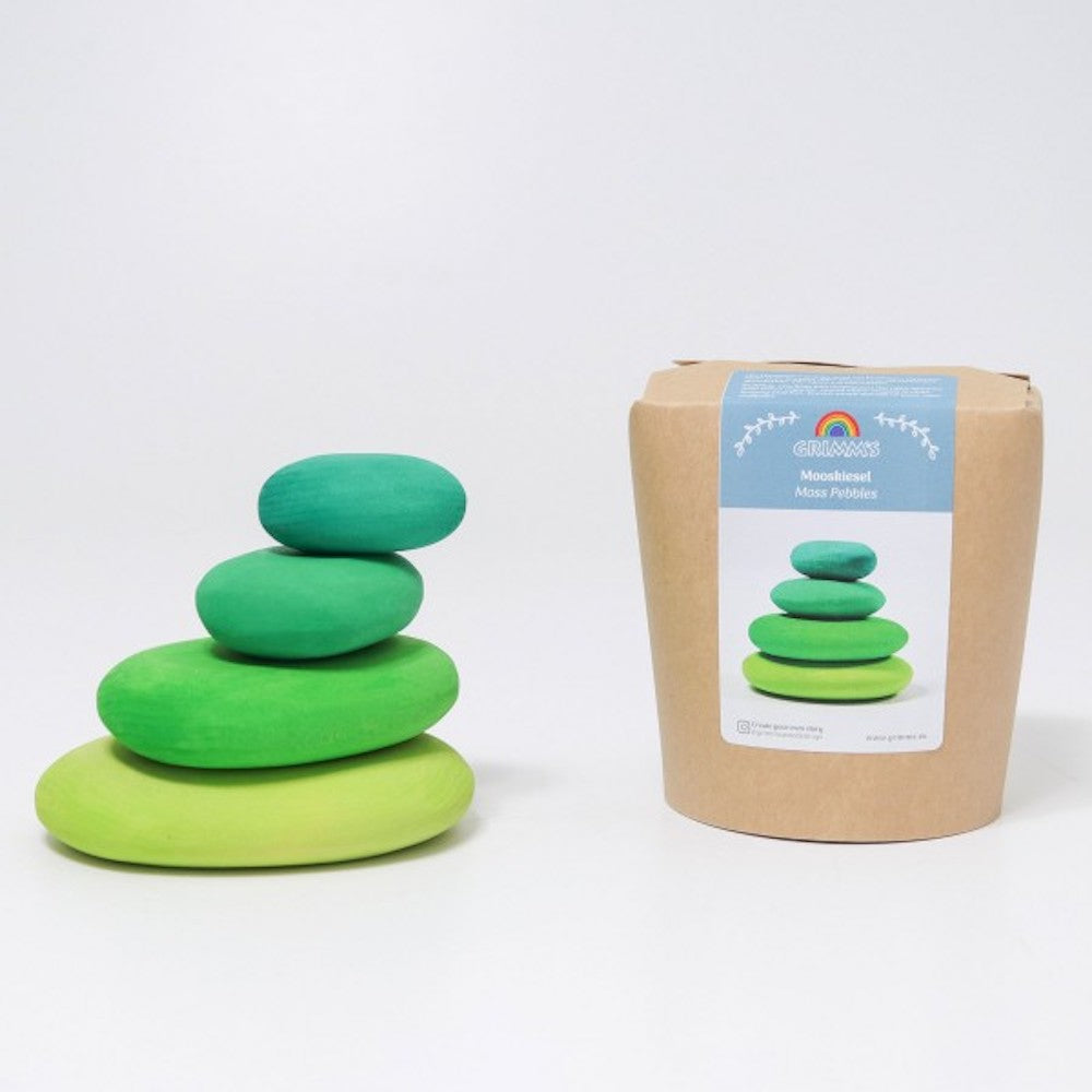 Stack of green stacking stones next to a cardboard box with a label on a white background
