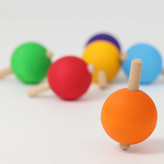 Colorful wooden toys with spherical ends on a white background