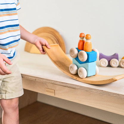 Child playing with wooden toys on a wooden shelf
