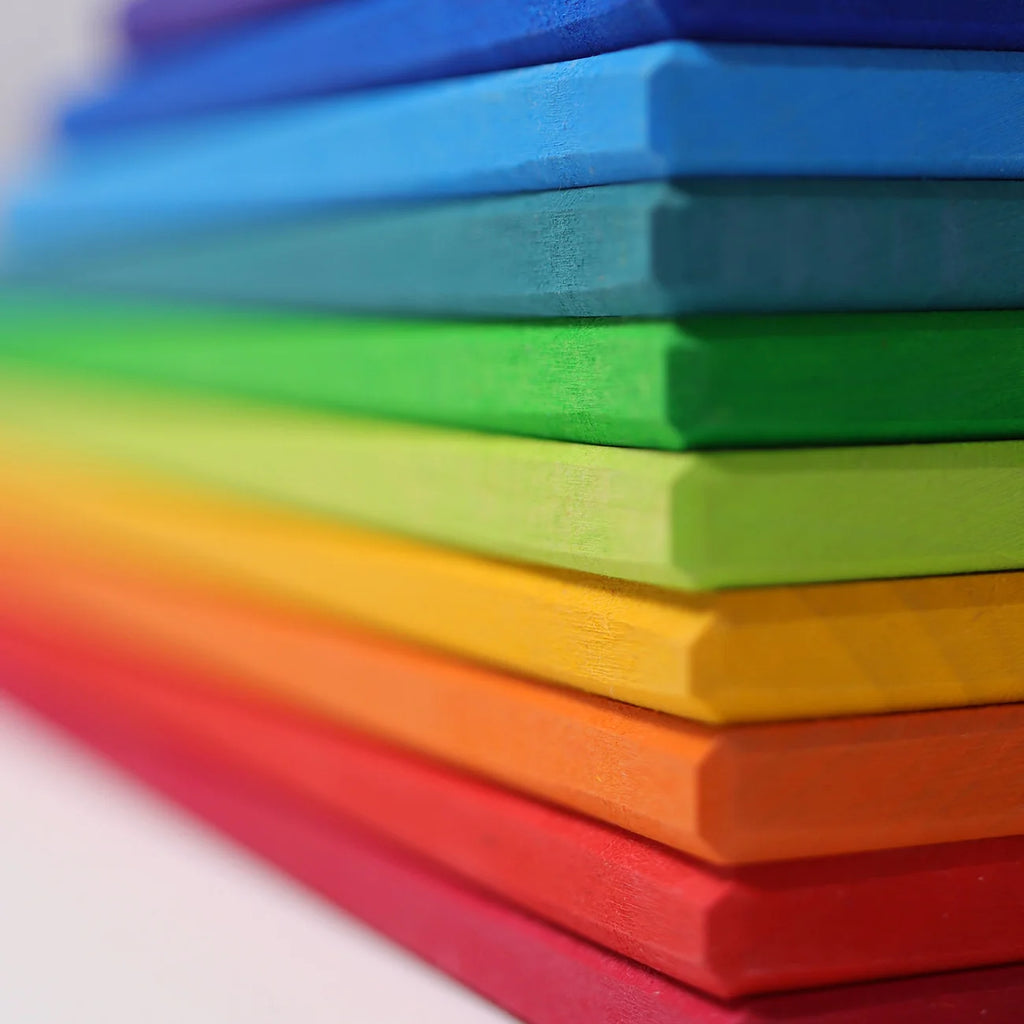 Stack of colorful foam pads in red, orange, yellow, green, blue, and purple.